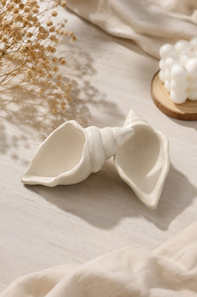 Handcrafted concrete conch shell candle vessels